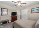 This bedroom features a ceiling fan, closet and tasteful art at 6810 E Almeria Rd, Scottsdale, AZ 85257