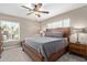 Comfortable bedroom with a large bed, ceiling fan, and bright natural light at 6810 E Almeria Rd, Scottsdale, AZ 85257