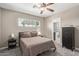 Cozy bedroom includes ceiling fan, window, and door to an ensuite bathroom at 6810 E Almeria Rd, Scottsdale, AZ 85257