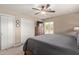 This bedroom features a ceiling fan, closet and dresser with a TV on top of it at 6810 E Almeria Rd, Scottsdale, AZ 85257