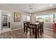 Dining area with a wooden table, chair set, and a bright window view at 6810 E Almeria Rd, Scottsdale, AZ 85257