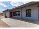 Charming single-story home with a grey exterior, covered walkway, and a red front door at 6810 E Almeria Rd, Scottsdale, AZ 85257
