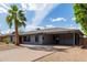 Charming single-story home with a desert landscape, covered parking, and a red front door at 6810 E Almeria Rd, Scottsdale, AZ 85257