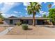 Charming single-story home with a desert landscape, covered parking, and a grey exterior at 6810 E Almeria Rd, Scottsdale, AZ 85257