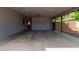 Spacious garage with built-in cabinets and a red door leading to the main house at 6810 E Almeria Rd, Scottsdale, AZ 85257