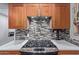 Close-up of a modern gas range and tile backsplash in a stylish kitchen at 6810 E Almeria Rd, Scottsdale, AZ 85257