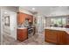 Modern kitchen featuring stainless steel appliances, tile backsplash, and wooden floors at 6810 E Almeria Rd, Scottsdale, AZ 85257