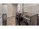 Laundry room featuring modern washer and dryer units, countertops, and wire shelving at 6810 E Almeria Rd, Scottsdale, AZ 85257