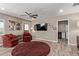 Comfortable living room with a ceiling fan, wood-look tile flooring, and a cozy seating area at 6810 E Almeria Rd, Scottsdale, AZ 85257