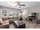 Bright living room featuring wood-look tile floors, a ceiling fan, and large windows at 6810 E Almeria Rd, Scottsdale, AZ 85257