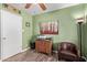 Inviting office space with green walls, wood-look floors, and a comfortable leather chair at 6810 E Almeria Rd, Scottsdale, AZ 85257