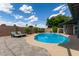 Backyard pool with lounge chairs, brick patio, and block wall fencing for privacy at 6810 E Almeria Rd, Scottsdale, AZ 85257