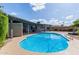 Backyard pool with lounge seating and covered patio, perfect for outdoor relaxation and entertainment at 6810 E Almeria Rd, Scottsdale, AZ 85257