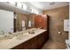 Modern bathroom with dual sinks, stone tile, and large vanity at 7161 E Rancho Vista Dr # 1013, Scottsdale, AZ 85251