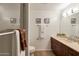 This bright bathroom features modern vanity, framed art, and tiled shower at 7161 E Rancho Vista Dr # 1013, Scottsdale, AZ 85251