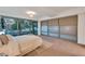 Spacious bedroom featuring a large window with views and plush carpeting at 7161 E Rancho Vista Dr # 1013, Scottsdale, AZ 85251