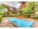 Large, clean pool with surrounding greenery and lounge seating area at 7161 E Rancho Vista Dr # 1013, Scottsdale, AZ 85251