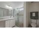 Bathroom with shower and glass doors, a single sink, and ceramic tile at 717 E Temple St, Chandler, AZ 85225