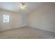 Cozy bedroom with neutral carpet, a ceiling fan, and a window at 717 E Temple St, Chandler, AZ 85225