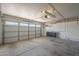 Spacious two car garage with bright lighting, shelving and an automatic garage door at 717 E Temple St, Chandler, AZ 85225
