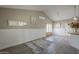 Bright living room with vaulted ceiling, light gray plank flooring and white painted wainscoting at 717 E Temple St, Chandler, AZ 85225