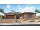 Inviting single story home with a brick driveway, 2-car garage, desert landscaping, and stone facade at 770 W Golden Ore Pass, Apache Junction, AZ 85120