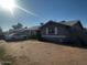 Side view of the home showcasing the architecture, fence, and surrounding landscape at 7808 W Clarendon Ave, Phoenix, AZ 85033