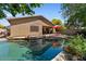 Picturesque backyard featuring a refreshing pool, covered patio, and a well-manicured lawn and landscaping at 8237 W Alex Ave, Peoria, AZ 85382