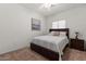 Cozy bedroom featuring a comfortable bed, decorative art, and a bright window at 8237 W Alex Ave, Peoria, AZ 85382