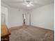 Spacious bedroom features neutral carpet, ceiling fan, and convenient access to the ensuite bathroom at 8237 W Alex Ave, Peoria, AZ 85382