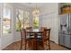 Bright dining area with a round table, wood floors, and large windows providing natural light at 8237 W Alex Ave, Peoria, AZ 85382