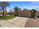 Inviting single-story home with a tidy front yard, a two-car garage, and a long driveway at 8237 W Alex Ave, Peoria, AZ 85382