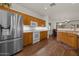 Spacious kitchen with stainless steel refrigerator and wooden cabinetry, seamlessly blending style and functionality at 8237 W Alex Ave, Peoria, AZ 85382