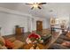 Open-concept living room with hardwood floors, neutral walls, and views of adjacent dining and kitchen areas at 8237 W Alex Ave, Peoria, AZ 85382