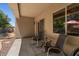 Cozy covered patio featuring comfortable seating and a sliding door with views of the refreshing backyard pool at 8237 W Alex Ave, Peoria, AZ 85382