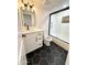Modern bathroom with black and white tile, new vanity and framed shower at 8625 E Belleview Pl # 1070, Scottsdale, AZ 85257