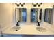Bathroom vanity featuring double sinks with quartz countertops and sleek black fixtures for a modern look at 8625 E Belleview Pl # 1070, Scottsdale, AZ 85257