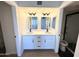 Bright bathroom showcases double sinks with quartz countertops, black faucets and black hardware at 8625 E Belleview Pl # 1070, Scottsdale, AZ 85257