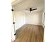 Bright, airy bedroom with wood floors and a ceiling fan at 8625 E Belleview Pl # 1070, Scottsdale, AZ 85257