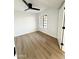 Clean bedroom featuring wood floors, a modern ceiling fan, and ample natural light at 8625 E Belleview Pl # 1070, Scottsdale, AZ 85257
