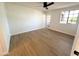Spacious bedroom boasting natural light from the window and featuring wood floors, and white walls at 8625 E Belleview Pl # 1070, Scottsdale, AZ 85257