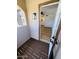 Inviting entryway featuring a wood porch and views into a bright bathroom with a modern vanity at 8625 E Belleview Pl # 1070, Scottsdale, AZ 85257