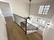 Bright entryway with high ceilings, modern light fixtures, and staircase with black iron railing at 8625 E Belleview Pl # 1070, Scottsdale, AZ 85257