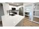 Bright kitchen featuring stainless appliances, modern finishes, and eat-in island with a view to the living room at 8625 E Belleview Pl # 1070, Scottsdale, AZ 85257