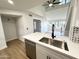 Open kitchen with bar island and stainless dishwasher at 8625 E Belleview Pl # 1070, Scottsdale, AZ 85257