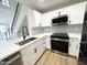 Kitchen with white cabinets, stainless steel appliances, and a black tiled backsplash at 8625 E Belleview Pl # 1070, Scottsdale, AZ 85257