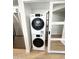 A washer and dryer laundry unit with shelving on the side near the kitchen at 8625 E Belleview Pl # 1070, Scottsdale, AZ 85257