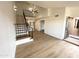 Bright living room with wood floors, staircase, black metal railing, and an open entryway providing a welcoming space at 8625 E Belleview Pl # 1070, Scottsdale, AZ 85257