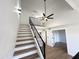 Bright staircase with wood and white treads leading up to landing at 8625 E Belleview Pl # 1070, Scottsdale, AZ 85257