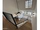 Upper-level staircase showcasing an open floor plan with light wood floors, a ceiling fan, and large windows at 8625 E Belleview Pl # 1070, Scottsdale, AZ 85257